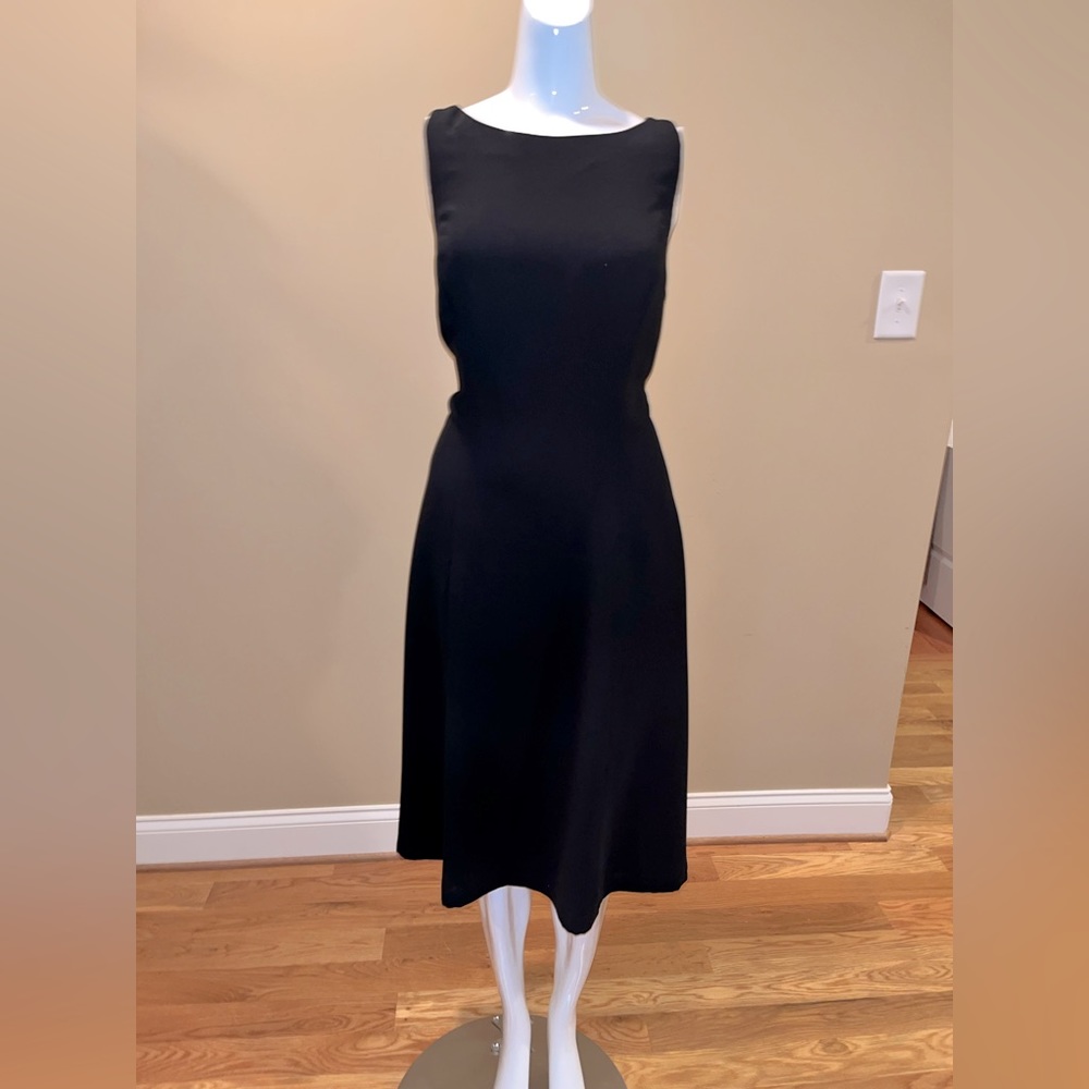 Ready for a night out in this lined black dress with jewel clasp back.